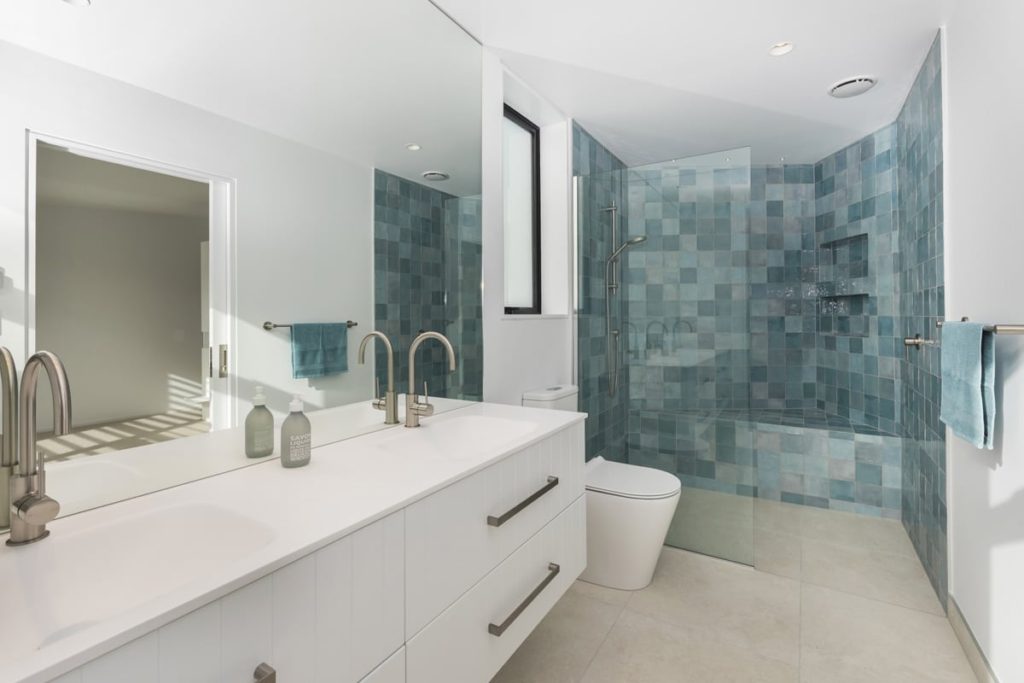 Bathroom with blue tiled shower of Mt Pleasant home